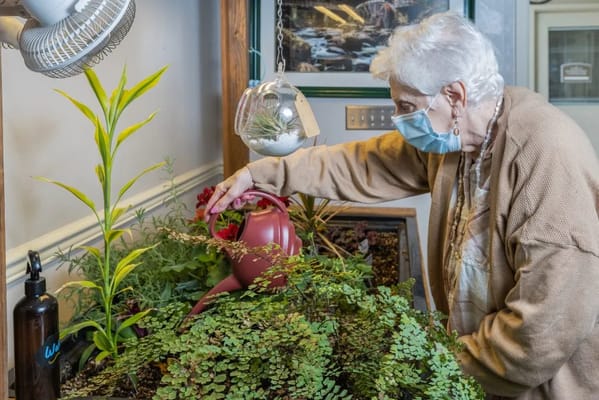 Resident gardening indoors at a senior living facility