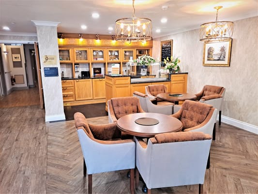 Common area seating with tables and decorative lighting