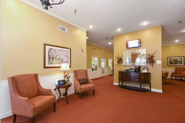 Cozy lobby with striped chairs and a decorative mirror