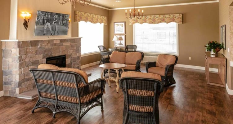 Cozy living room with wicker furniture and a stone fireplace