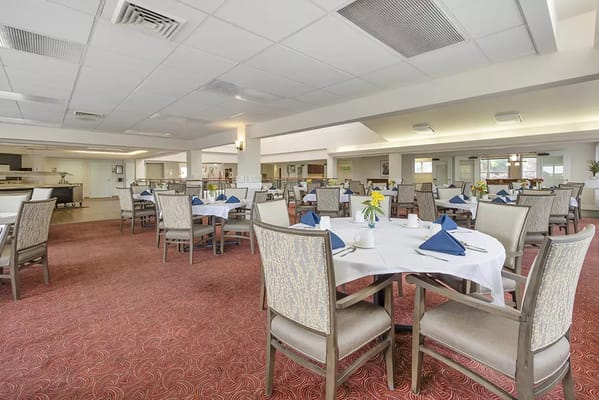 Dining room with tables set for residents