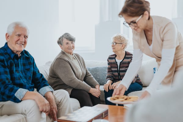 Residents enjoying conversation with a staff member.