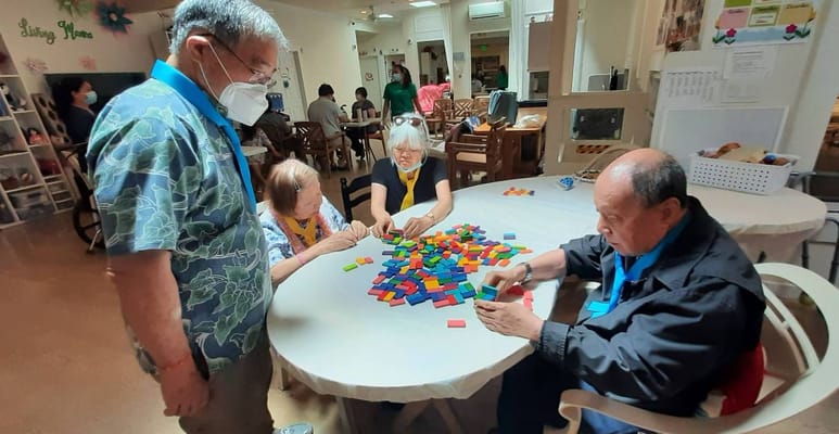 Residents engaging in a group activity with colorful blocks