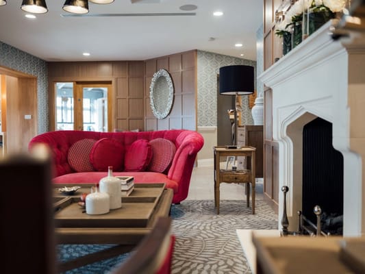 Interior of a cozy common area with pink seating