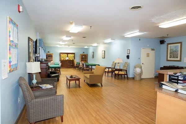 Common area of a nursing care facility with seating and natural light