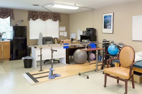 Physical therapy room with equipment and furniture