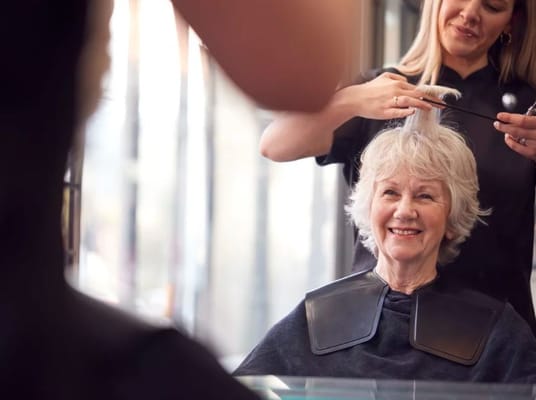 A senior woman enjoying a hair salon service