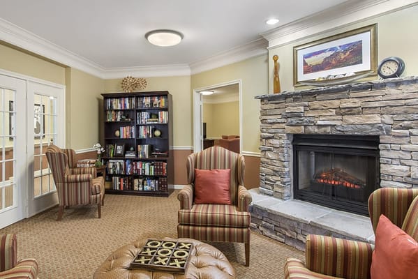 Cozy common area with a fireplace and bookshelves