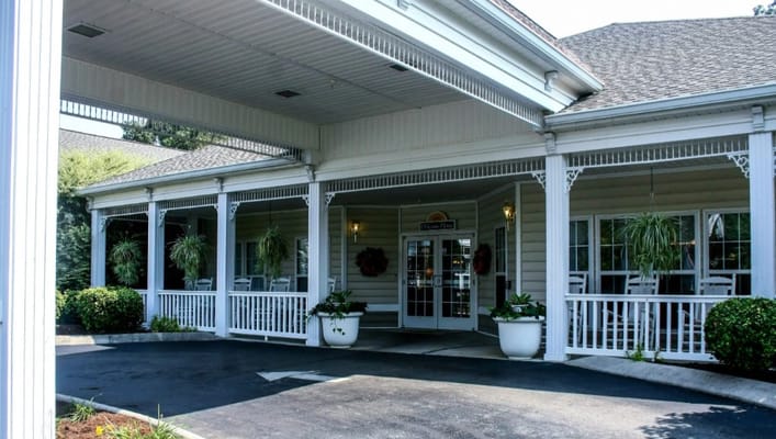 Front entrance of Charter Senior Living facility with porch