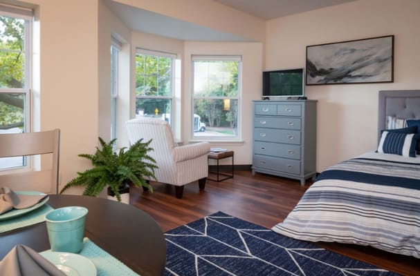 Cozy interior of a resident room with a bed and chair