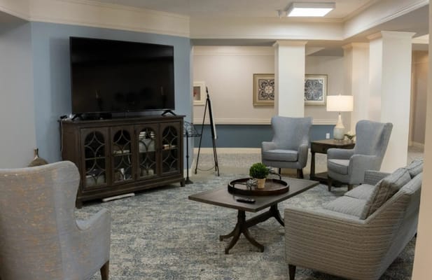 Cozy lounge area with comfortable seating and a TV