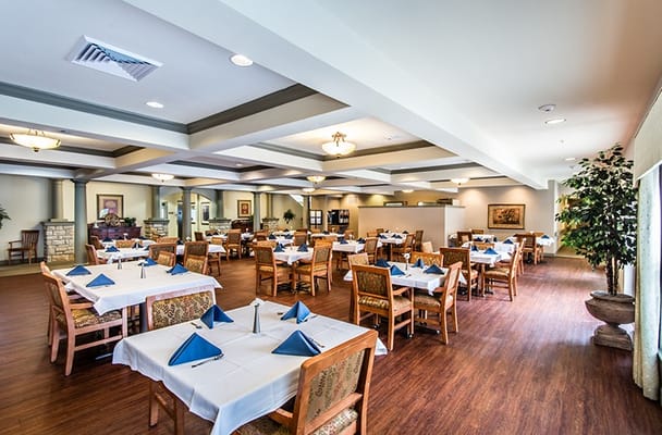 Dining area with tables set for residents