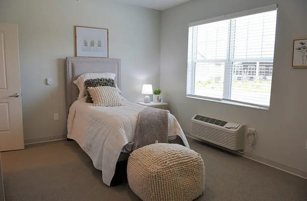Cozy private bedroom with natural light and neutral decor