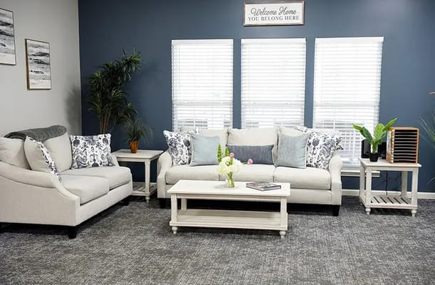 Bright and cozy common area seating with plants and decor