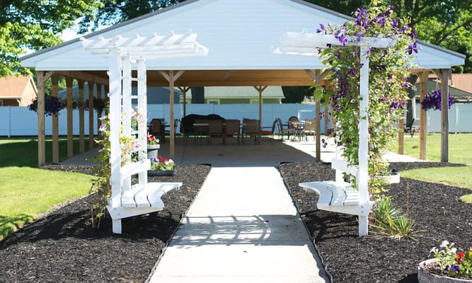 Paved walkway leading to a covered outdoor seating area