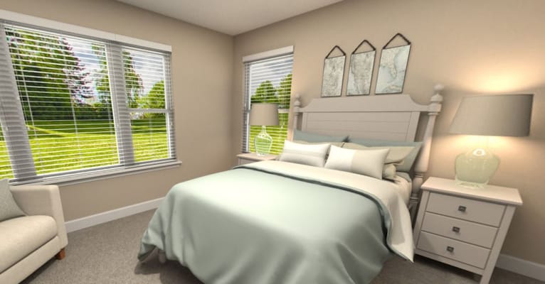 Comfortable bedroom with a green duvet and natural light