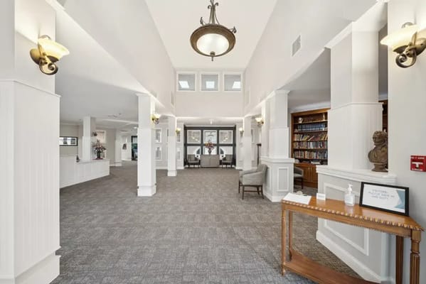 Spacious lobby with seating and a library area