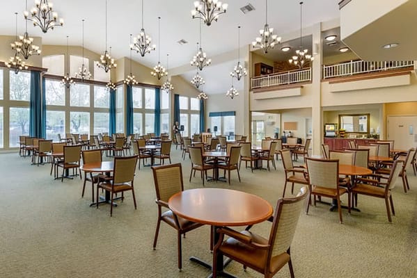 Spacious dining room with tables and chandeliers
