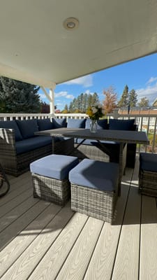 Outdoor seating area with a view of trees and blue sky