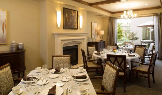 Elegant dining room with set tables and outdoor view
