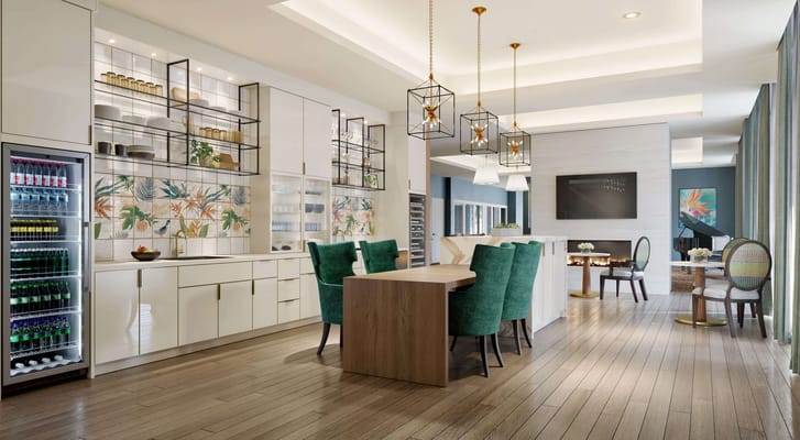 Modern common area with kitchen and seating at Sunrise of Coral Gables.