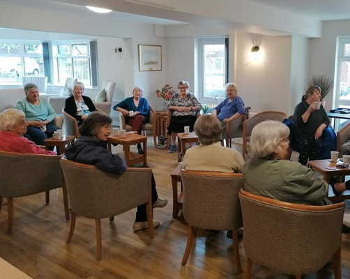 Residents enjoying coffee in a cozy common area