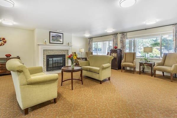 Bright and inviting common area with seating and fireplace