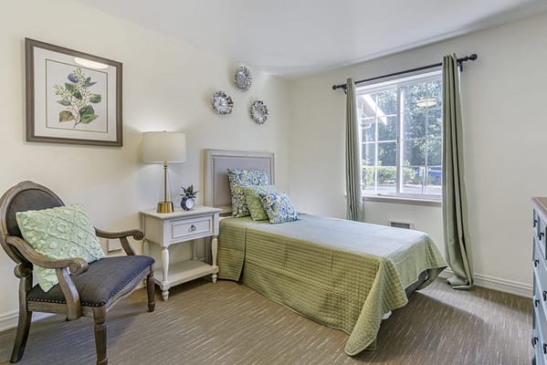 Cozy resident room with green accents and window