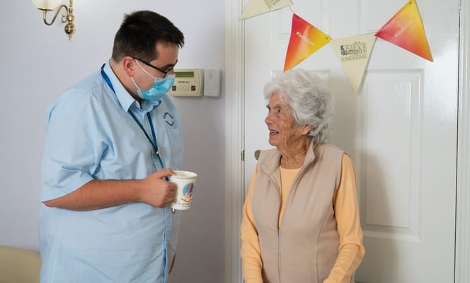 Staff member talking with a resident in a common area