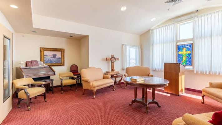 Quiet common area with seating and stained glass window
