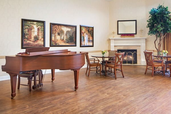 Cozy lounge with a grand piano and seating area