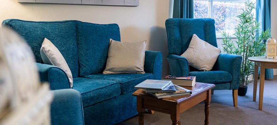 Comfortable seating area with blue sofas and a coffee table