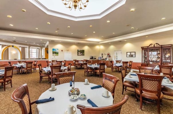 Dining area with well-set tables and a chandelier