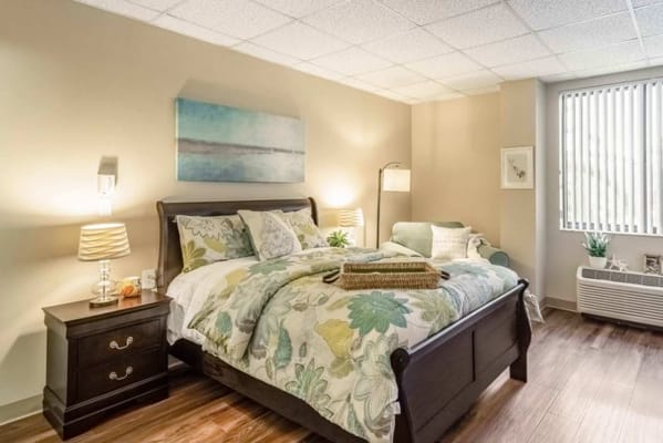 Cozy private resident room with floral bedding