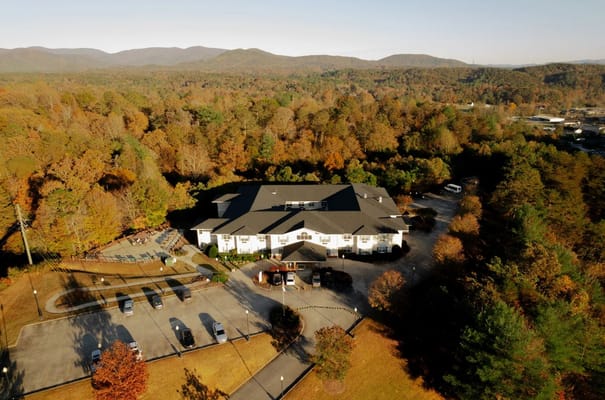 Aerial view of a senior living facility surrounded by fall foliage