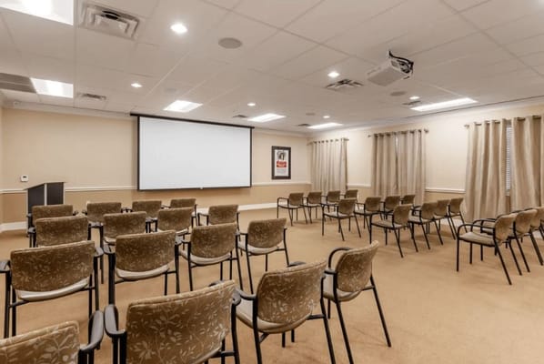 An interior activity room with chairs arranged for a meeting