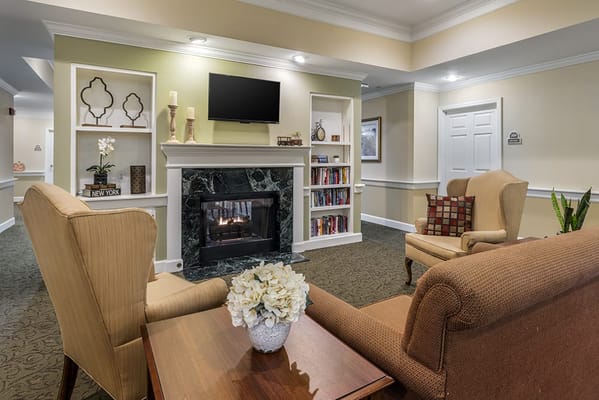 Cozy seating area with a fireplace in the facility
