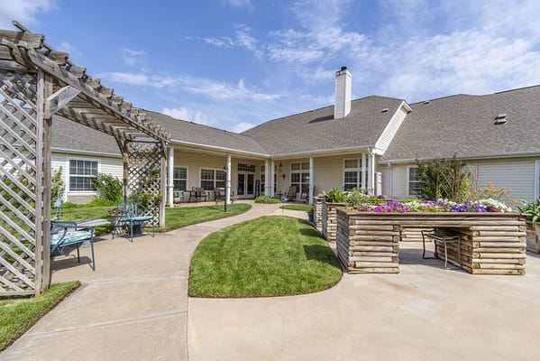 Outdoor patio area with seating and flower beds