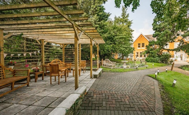 Outdoor seating area with a pathway and greenery