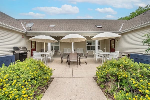Outdoor seating area with tables and umbrellas