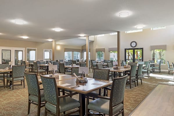 Bright dining room with tables and chairs arranged