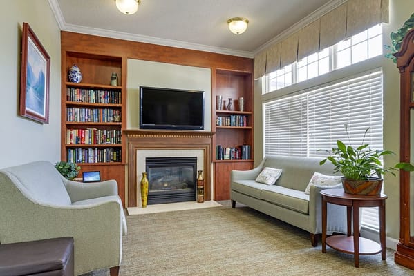 Comfortable lounge area with bookshelves and sofa