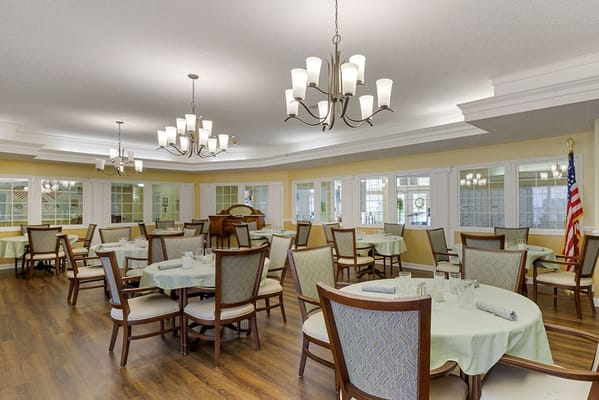 Bright dining area with tables and chairs set up