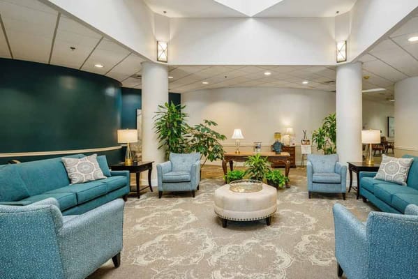 Lobby seating area with teal sofas and plants