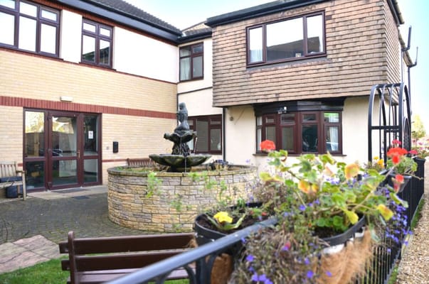 Exterior view of Field House Care Home with landscaped garden