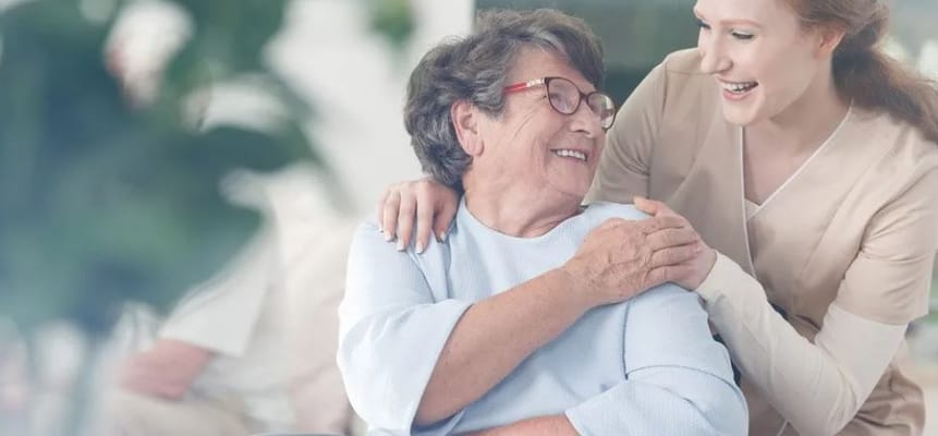 A caregiver and a resident sharing a joyful moment