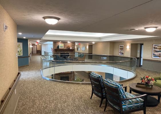 Interior view of the Glen Meadows Retirement Community lobby featuring seating and a circular balcony.
