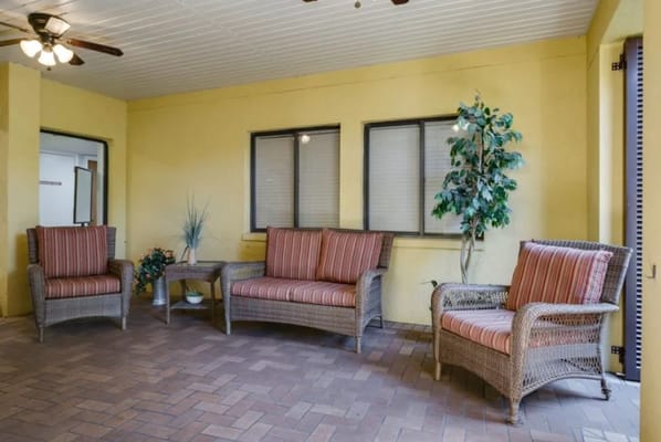 Interior common area with wicker furniture and windows