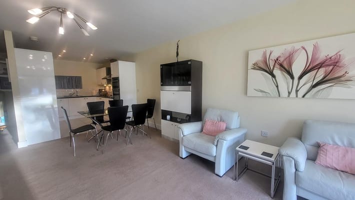 Bright interior common area with seating and dining table
