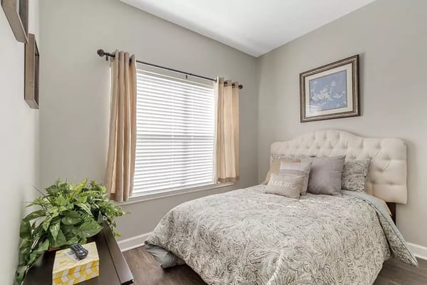 Cozy bedroom with a decorated bed and window